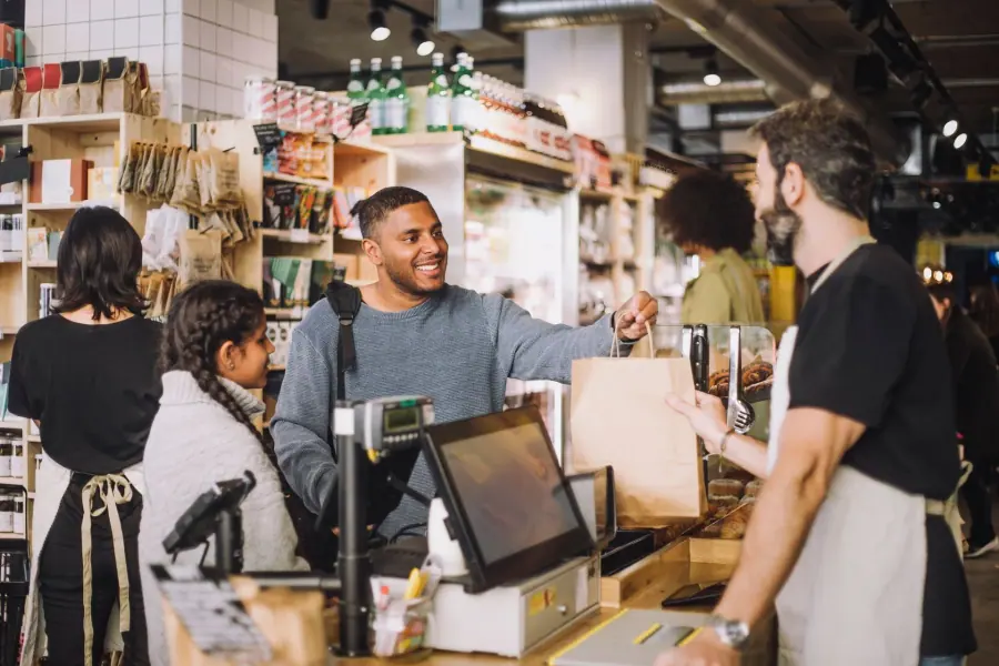 Retail associate assisting a customer at the counter